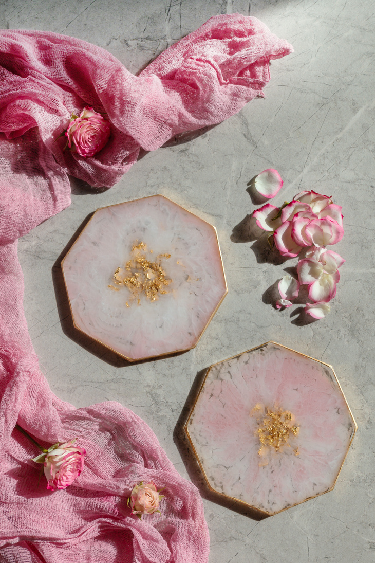 Epoxy resin pink colored round plates. Resin art. Top view,